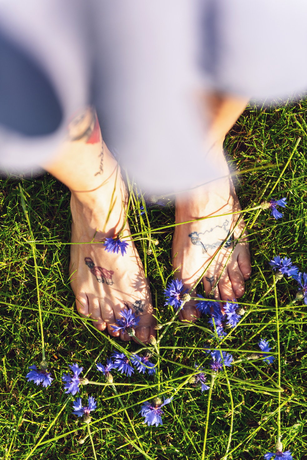 Woman's Bare Feet Standing  on Grass